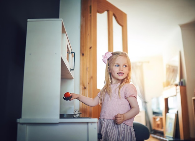 Dinners on me tonight Shot of an adorable little girl playing with a toy kitchen set at home