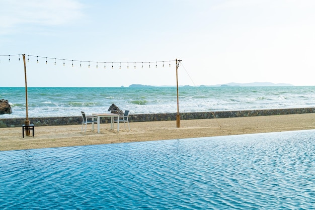 Dinning table and chair on beach with sea background