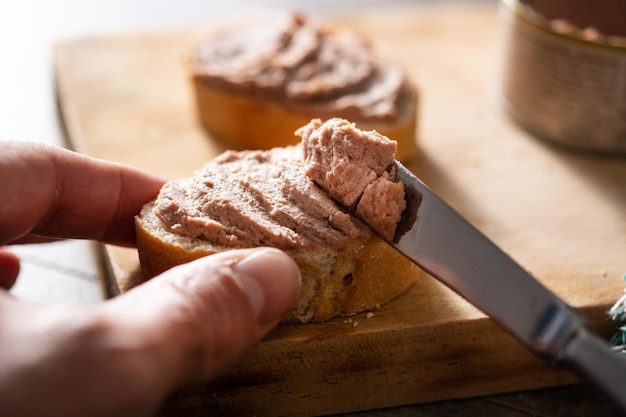 Dipping toasted bread with pork liver pate