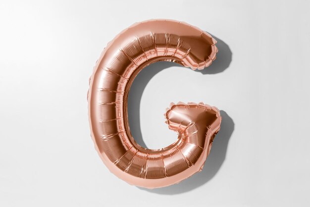 Directly above shot of alphabet balloon against white background