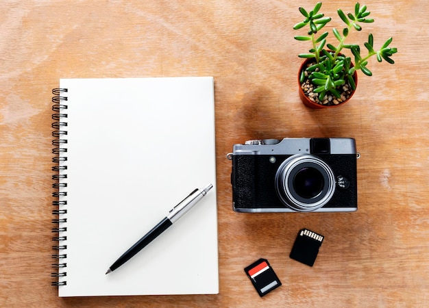 Photo directly above shot of book and camera on table