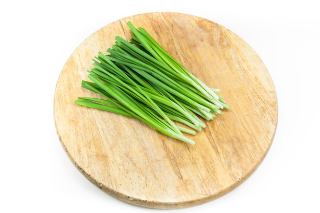 Directly above shot of chopped leaf on cutting board against white background