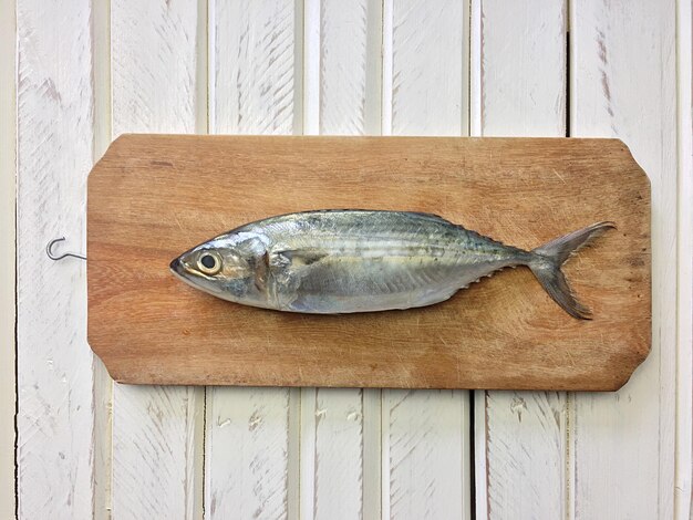 Photo directly above shot of fish on cutting board over table