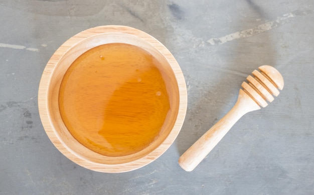 Photo directly above shot of honey in wooden bowl on table