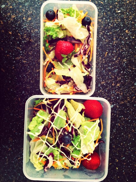 Photo directly above shot of salad in containers on table