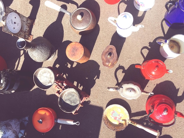 Photo directly above shot of various teapots and vase at market stall for sale