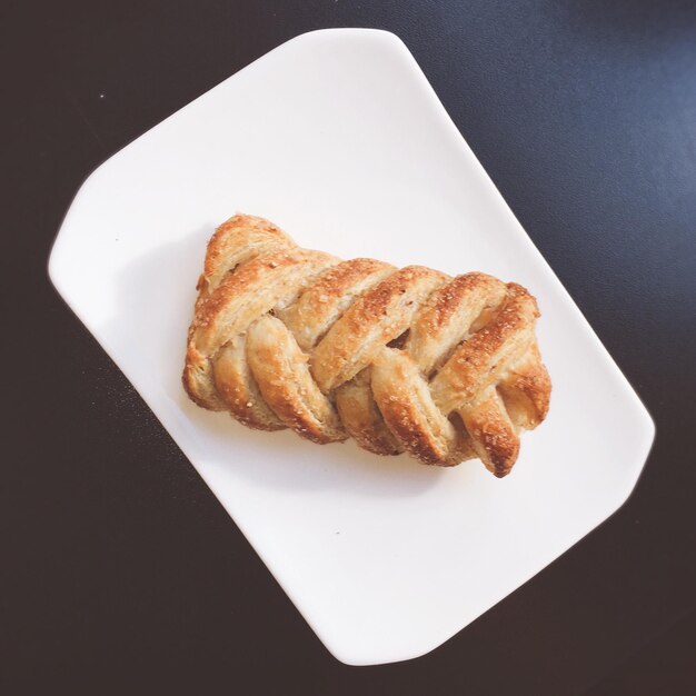 Directly above view of fresh croissant served in plate on table