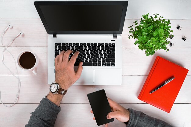 Directly above view of human hands typing on laptop