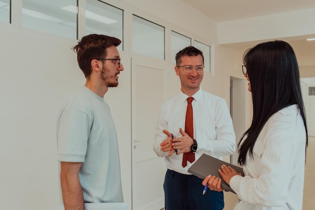 The director conducts a conversation with the secretary and a young programmer in a modern and spaci