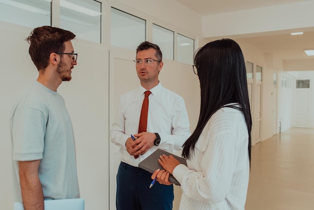 The director conducts a conversation with the secretary and a young programmer in a modern and spaci