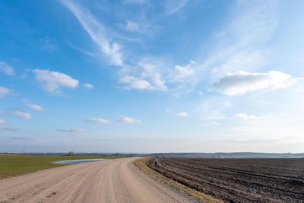 Dirt road in a field outside the city