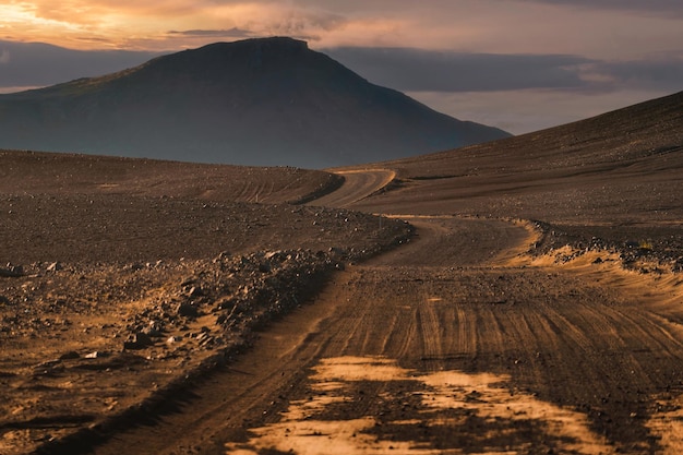 Dirt road and volcanic mountain to Landmannalaugar among remote wilderness in the evening at Icelandic Highlands