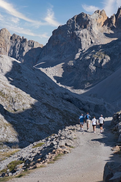 Dirt road with people walking in the mountains