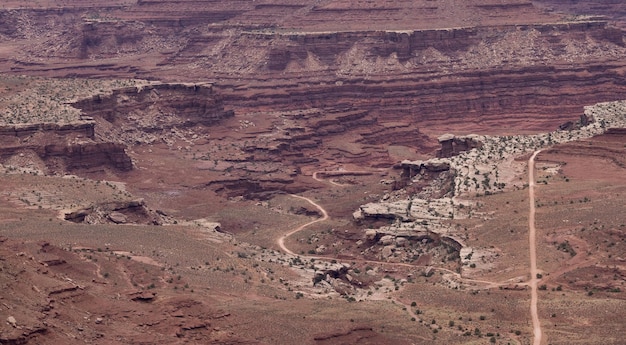 Dirt route in Desert Canyon with Scenic American Landscape and Red Rock Mountains