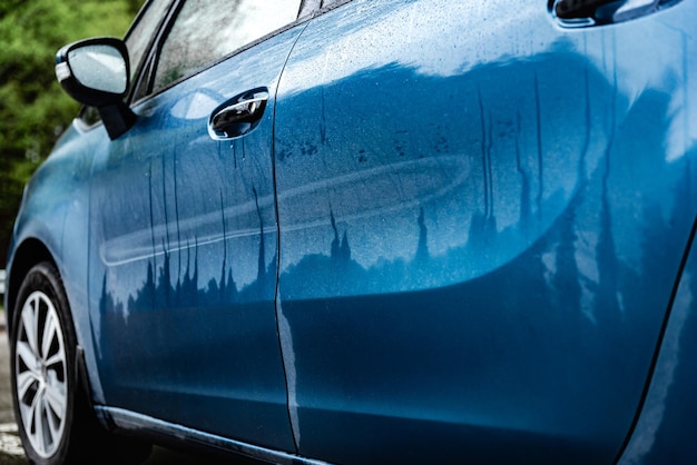 Dirty blue car after rain.