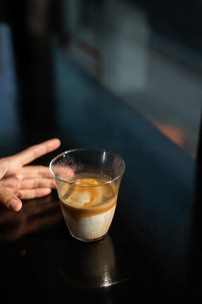 Dirty Coffee - A glass of espresso shot mixed with cold fresh milk in coffee shop cafe and restauran