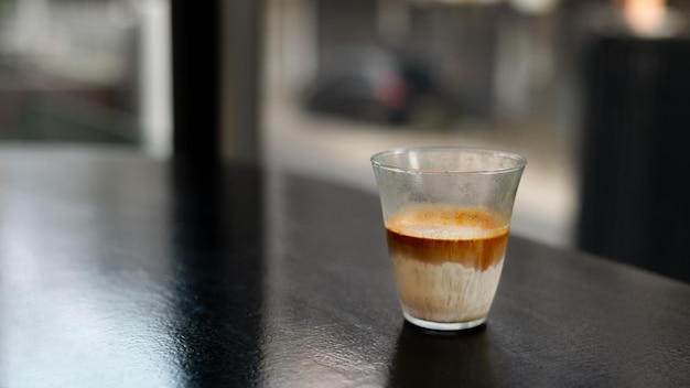 Dirty Coffee - A glass of espresso shot mixed with cold fresh milk in coffee shop cafe and restauran