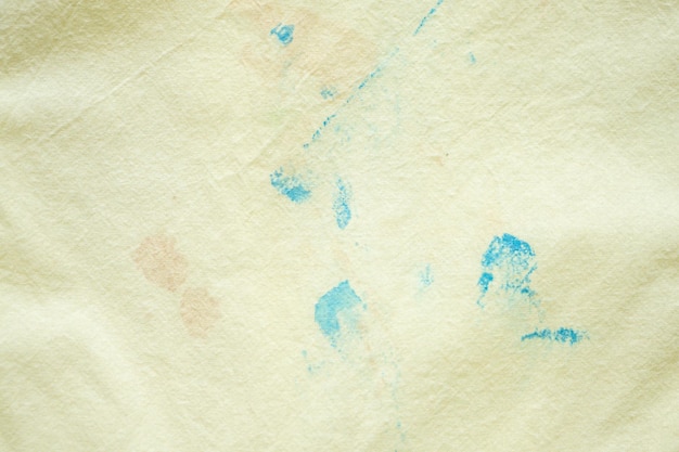 Dirty color stain on yellow fabric texture background