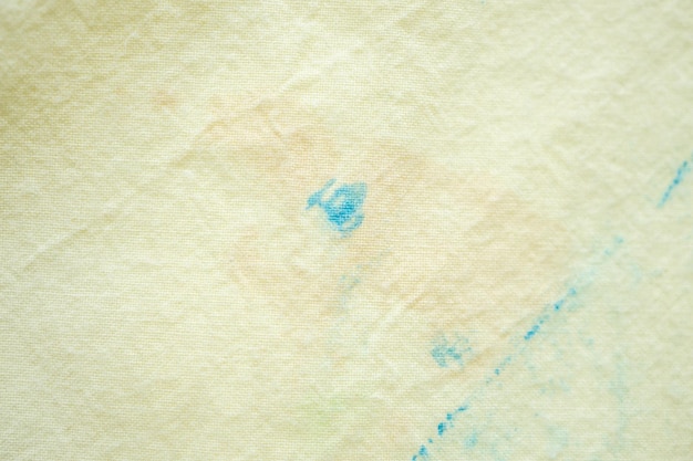 Dirty color stain on yellow fabric texture background