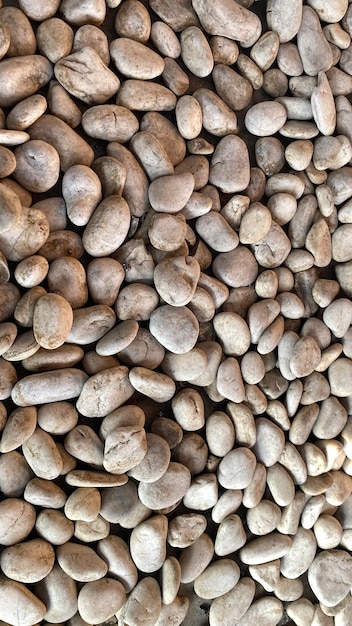 dirty pebbles close up gravel or tiny small stone with dirt and brown for background decoration