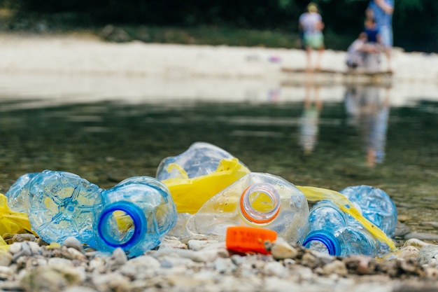 Dirty plastic bottles and bags in water