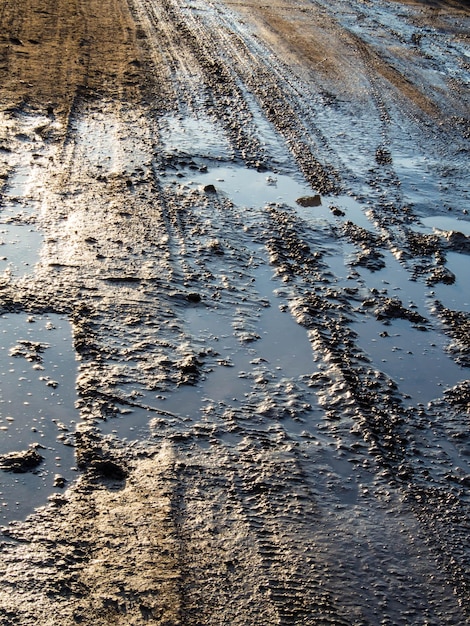 Dirty rural road with deep tire tracks