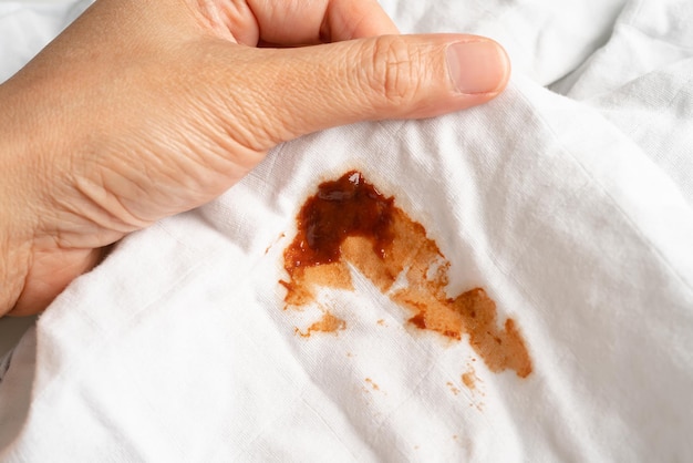 Dirty tomato sauce stain or ketchup on cloth to wash with washing powder cleaning housework concept