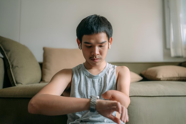 disable man with a watch on his left arm is sitting on a chair man looking at watch after exercise