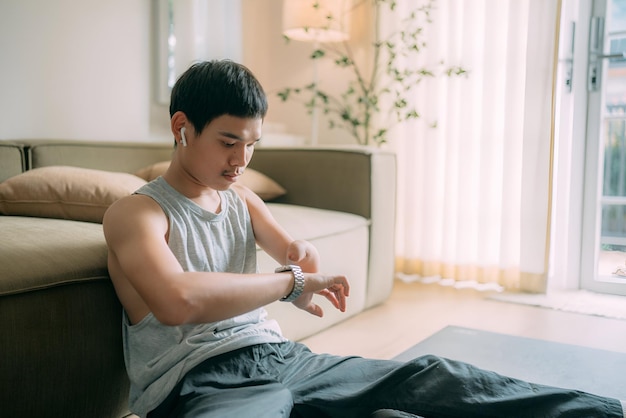 disable man with a watch on his left arm is sitting on a chair man looking at watch after exercise