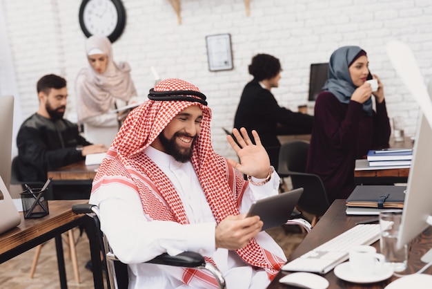 Disabled Arab Video Calling Coffee Break at Work.