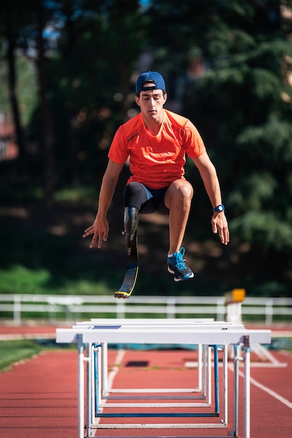 Disabled man athlete training with leg prosthesis. Disabled Sport Concept