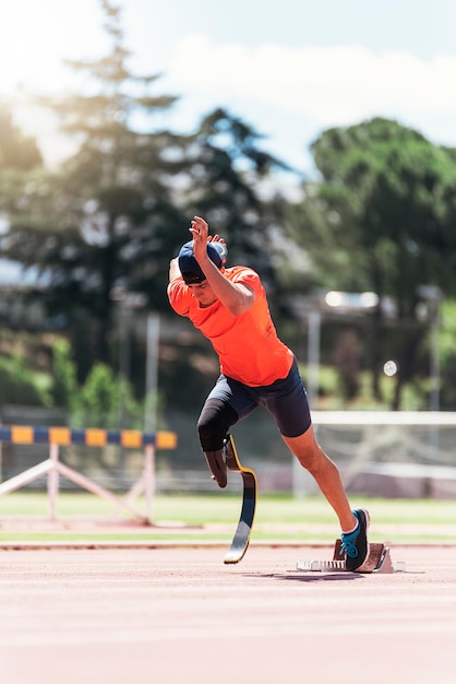 Disabled man athlete training with leg prosthesis. Paralympic Sport Concept.