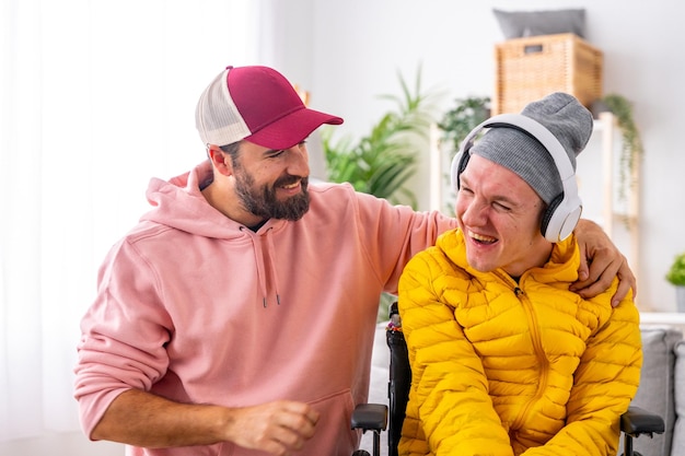 Photo disabled man and caregiver during art therapy session with music