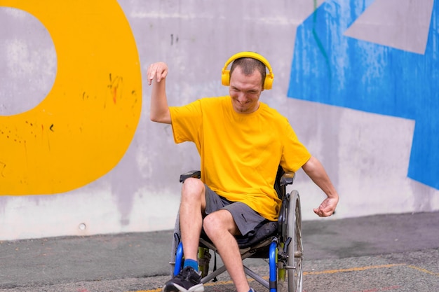 Disabled person in a wheelchair listening to music with headphones dancing and smiling