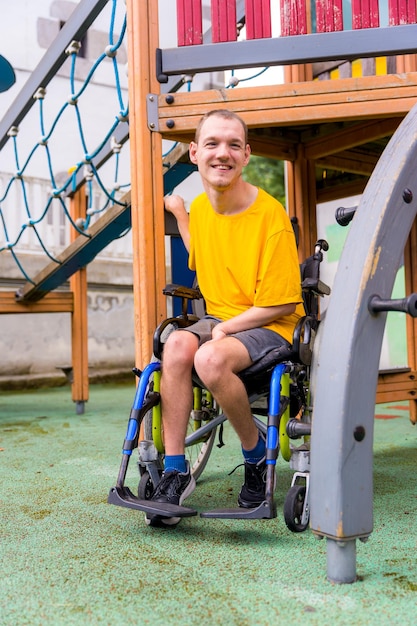 A disabled person in a wheelchair on the swings of a playground having fun