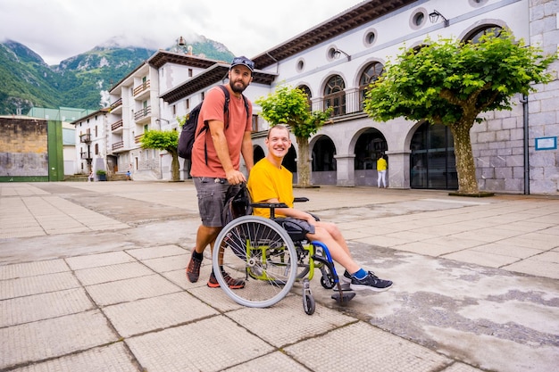 A disabled person in a wheelchair walking through the town square with a friend