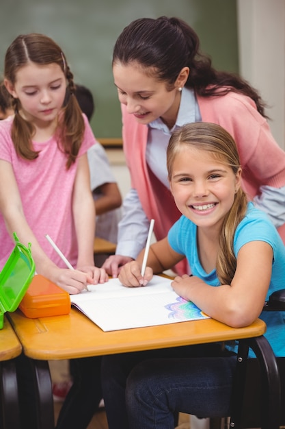 Disabled pupil smiling at camera in classroom