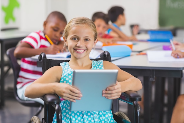 Disabled schoolgirl using digital tablet