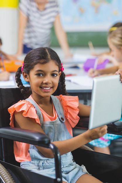 Disabled schoolgirl using digital tablet