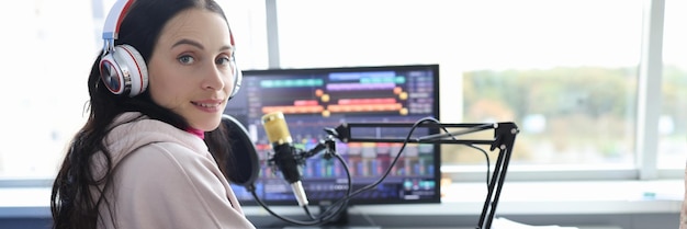 Disabled woman works as radio presenter in wheelchair in studio cybersport for disabled people