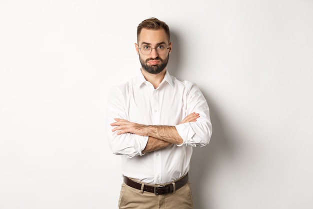 Disappointed businessman pouting, standing displeased against white background