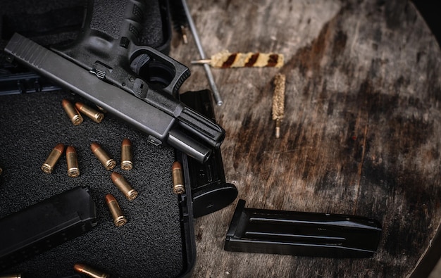 Disassembly and cleaning Maintaining a 9mm semiautomatic pistol on a wooden table