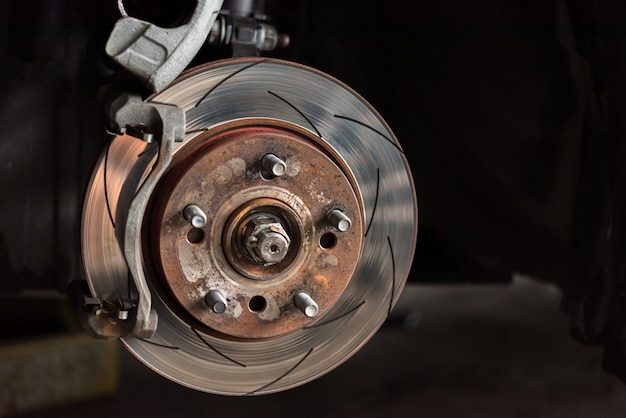 Photo disc brake and asbestos brake pads at car garage