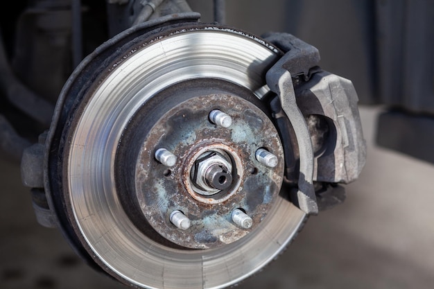 Disc brake of the vehicle for repair in process of tire replacement Car brake repairing in garage