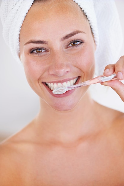 Disciplined brushing equals sparkling teeth Portrait of a stunning woman brushing her teeth