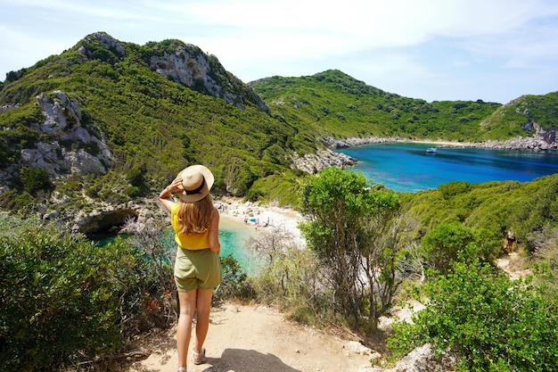 Discovering Greece Hiker woman enjoying amazing lookout of Porto Timoni on Corfu Island Greece