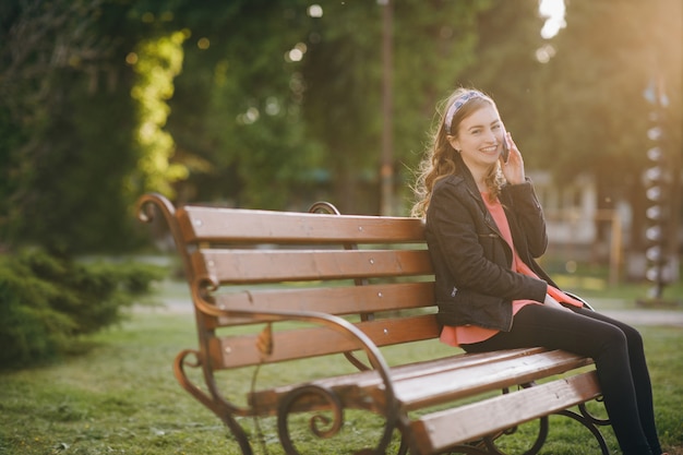 Discussing ideas for weekends during work break sitting outdoors on city bench.