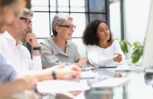 Discussion of business people in the office sitting at the table