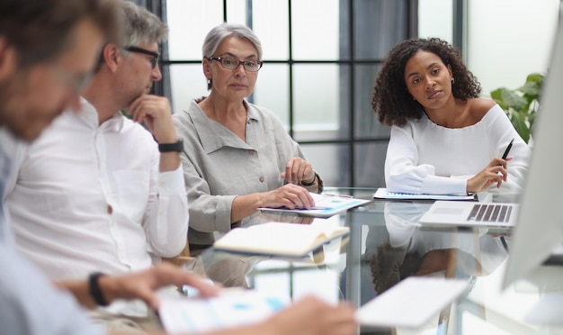 Discussion of business people in the office sitting at the table