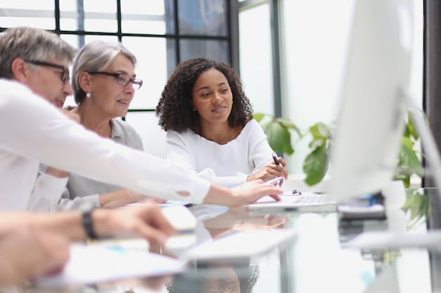 Discussion of business people in the office sitting at the table